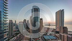 Panoramic view of the Dubai Marina and JBR area and the famous Ferris Wheel aerial day to night timelapse