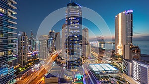 Panoramic view of the Dubai Marina and JBR area and the famous Ferris Wheel aerial day to night timelapse