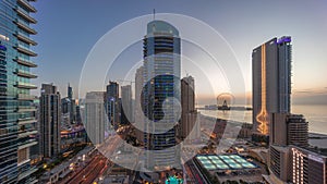 Panoramic view of the Dubai Marina and JBR area and the famous Ferris Wheel aerial day to night timelapse