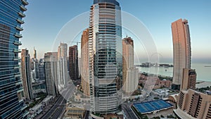 Panoramic view of the Dubai Marina and JBR area and the famous Ferris Wheel aerial night to day timelapse