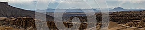 Panoramic view of Earth forest landform and mountains behind with cloudy sky in Zhada County