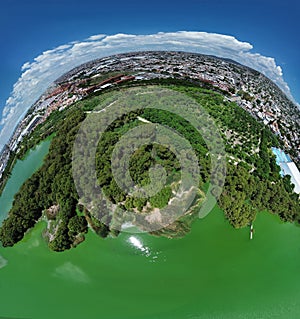 Panoramic view of earth, water, vegetation, sky with human constructions