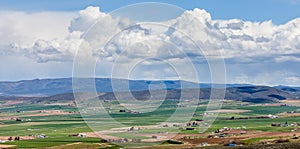 A panoramic view of Ellensburg, WA with a thunderstorm in the distance