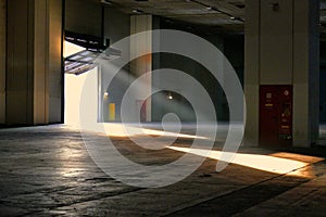 Panoramic view of empty industrial plant site beam of sunlight enters the raised gate