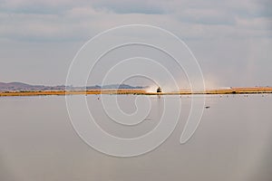 Panoramic view of Enkongo Narok Swamp with safari vehicle at the background at Amboseli National Park in Kenya