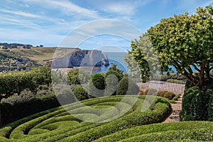 View of Etretat coastline with its famous natural stone arch from the Etretat gardens. Normandy, France. photo