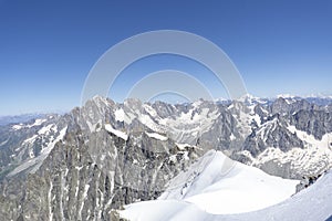 A panoramic view of European Alps on a sunny day. Mount Blanc as a highest mountain in Europe covered with snow and glacier