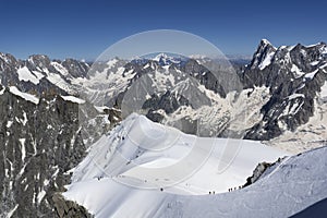 A panoramic view of European Alps on a sunny day. Mount Blanc as a highest mountain in Europe covered with snow and glacier.