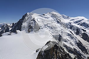 A panoramic view of European Alps on a sunny day. Mount Blanc as a highest mountain in Europe covered with snow and glacier