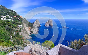 Panoramic view of famous Faraglioni Rocks, most visited travel attraction of Capri Island, Italy.