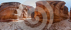 Panoramic view of the famous Limestone tiled streets and water canals of ancient Siq of Petra, Jordan,