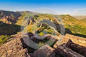 View of the famous Smbataberd fortress in the Armenian Transcaucasia with gorgeous views of mountain valleys at golden photo