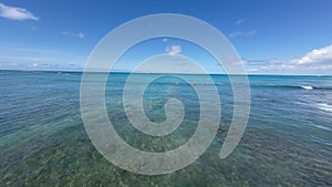 Panoramic view of the famous waikiki beach from the ocean at water level. Turquoise color of the tropical waters of the