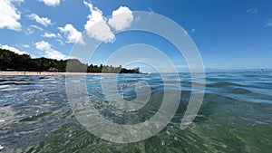 Panoramic view of the famous waikiki beach from the ocean at water level. Turquoise color of the tropical waters of the