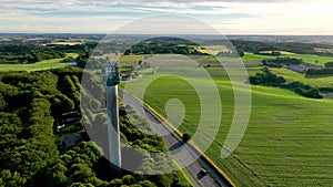 Panoramic view of farmers` fields, sunset and observation tower.