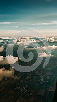 Panoramic view of fields and clouds from airplane window
