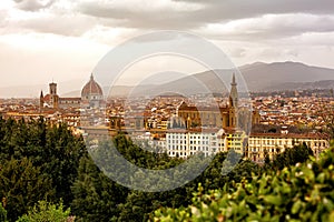 Panoramic View of Florence or Firenze, Italy. Cityscape in a cloudy early spring evening, green park on foreground and