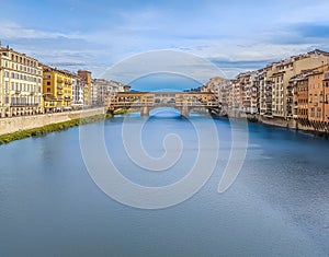 Panoramic view of florence firenze old bridge ponte vecchio under blue sky with typical old house near river