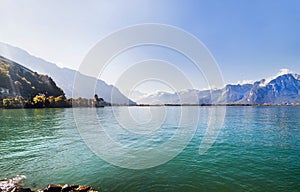 Panoramic view of Geneva lake and Chillon castle among mountains in Switzerland