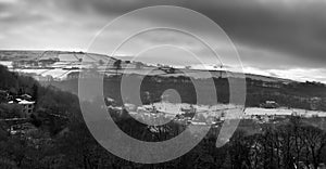 Panoramic view of a glowing orange sunset in a cloudy twilight winter sky with snow covered fields in calderdale west yorkshire