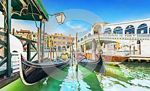 Panoramic view of Gondolas and boat at their moorings against famous Rialto Bridge at Grand Canal in Venice, Italy, Europe