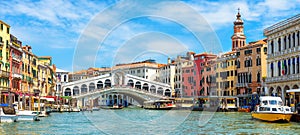 Panoramic view of Grand Canal, Venice, Italy. Rialto Bridge in the distance. It is famous landmark of Venice