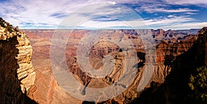 Panoramic view of Grand Canyon on sunny day.