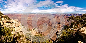 Panoramic view of Grand Canyon on sunny day.