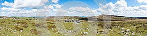Panoramic view of the granite bedrock outcrops at Top Tor, Dartmoor National Park, Devon, UK, on a bright cloudy day