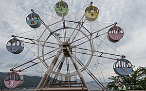 Panoramic view on great Ferris Wheel with round, colorful cabins with printed Animals. Located in Amanohashidate View Land, Miyazu