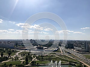 Panoramic view from a great height on a beautiful green city with many roads and high-rise buildings, buildings. View of the city