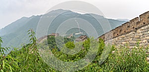 Panoramic view of Great Wall of China with a green trees in a background