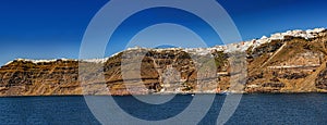 Panoramic view of the Greek island of Santorni, as seen from cruise ship at sea.