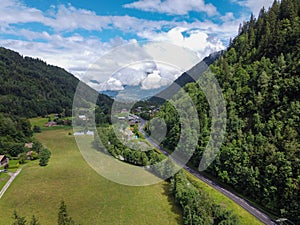 Panoramic view on green Alpine spruce and pine tree forests and meadows near Saint-Gervais-les-Bains, Savoy. France