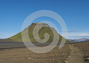 Panoramic view on green Hattafell mountain in Volcanic landscape behind Emstrur camping site with hikers on Laugavegur