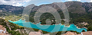 Panoramic view of the Guadalest reservoir at the foot of the town of Guadalest with the Sierra de Serrella in the background in