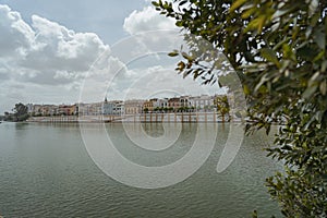 Panoramic view of the Guadalquivir river with Triana neighborhood in the background.