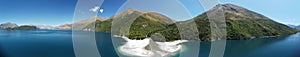 Panoramic view of Hawai island with a white seashore, green mountains and sky background