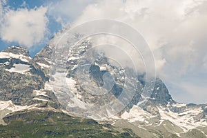 Panoramic view of high massif of Monte Cervino Matterhorn covered by cloud in Aosta Valley