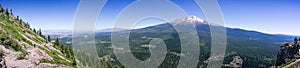 Panoramic view of the hiking trail to Black Butte's top and the forests and summit of Shasta mountain covered in snow; Siskiyou