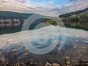 Panoramic view from the hill on bend of the river. Beautiful summer landscape. Colorful clouds of the morning sky. Dniester Canyon