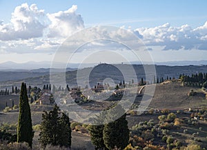 Panoramic view on hills near Pienza, Tuscany, Italy. Tuscan landscape with cypress trees, vineyards, forests and ploughed fields