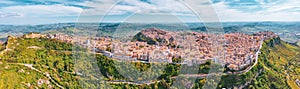 Panoramic view of the hills, the town of Enna on the valley with green meadows and forests in Sicily