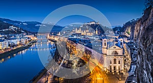 Panoramic view of historic city of Salzburg with Festung Hohensalzburg and river Salzach during blue hour, Salzburger Land,