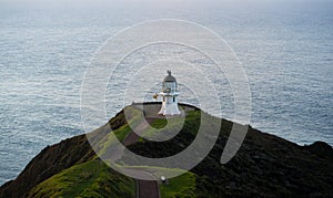 Panoramic view of historic white lighthouse landmark perched on oceanside clifftop Cape Reinga Northland New Zealand