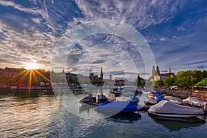 Panoramic view of historic Zurich downtown with Fraumunster and Grossmunster churches at zurich Lake during sunset, Switzerland