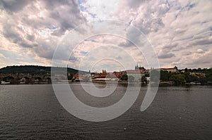 Panoramic view of historical center of Prague, Charles Bridge and Vltava river, Saint Vitus Cathedral at cloudy summer day