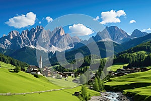 Panoramic view of idyllic mountain scenery in the Alps with fresh green meadows in bloom on a beautiful sunny day in springtime