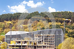 Panoramic view of industrial construction site with cranes