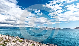 Panoramic view of island coastline landscape, calm water, clear sky on a sunny vacation day. Seaside resort as destination